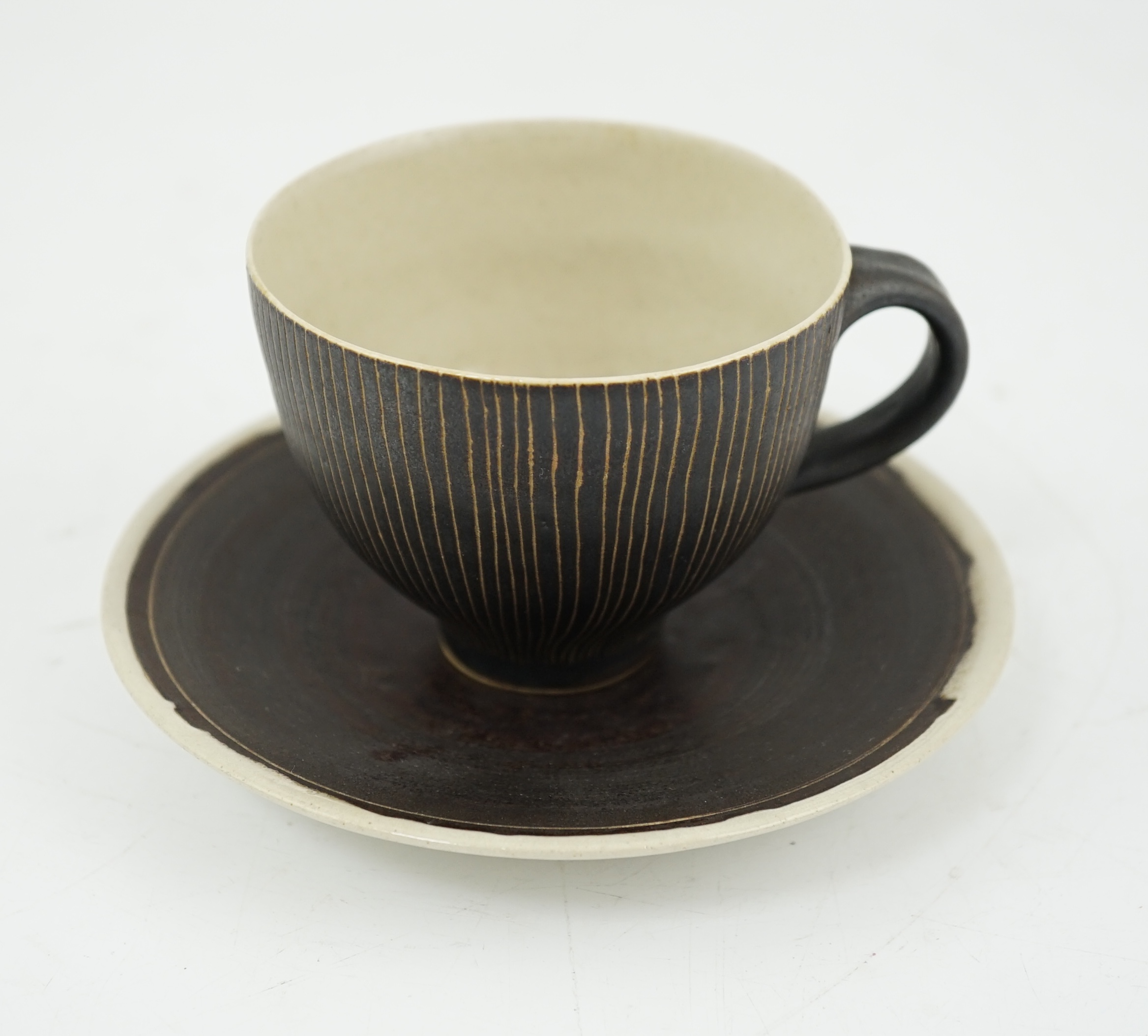 Dame Lucie Rie D.B.E. (1902-1995), a manganese glazed coffee cup and saucer